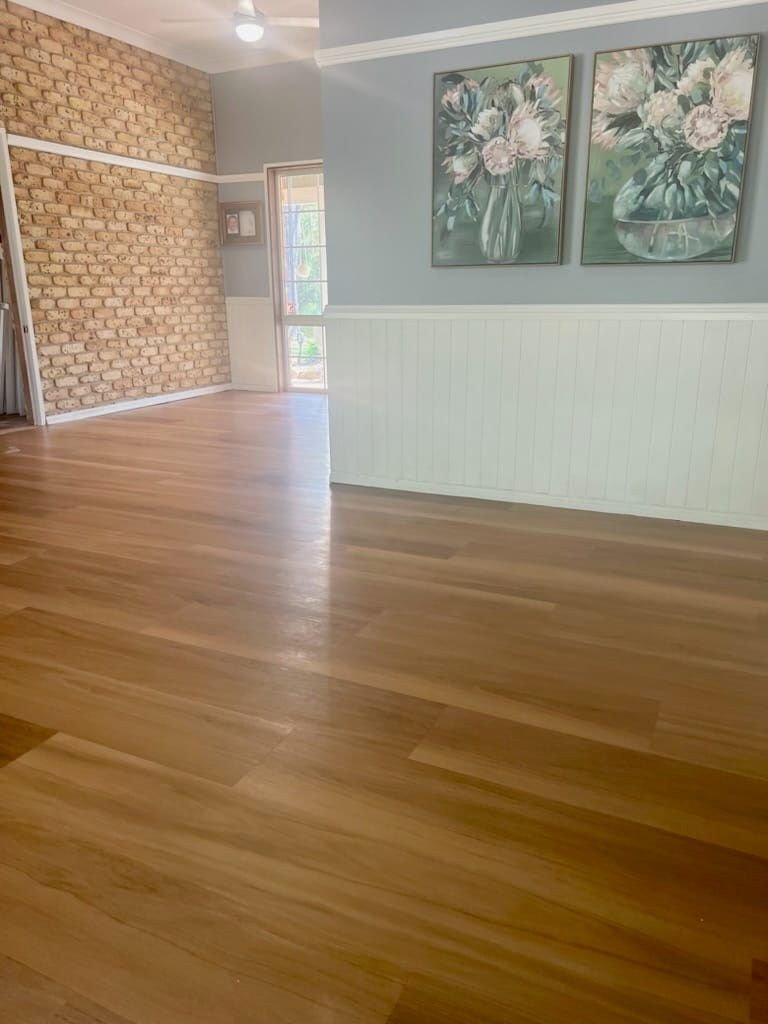 Wooden-Floored Room With a Brick Wall and White Wainscoting — BLB Flooring Solutions in Maitland, NSW