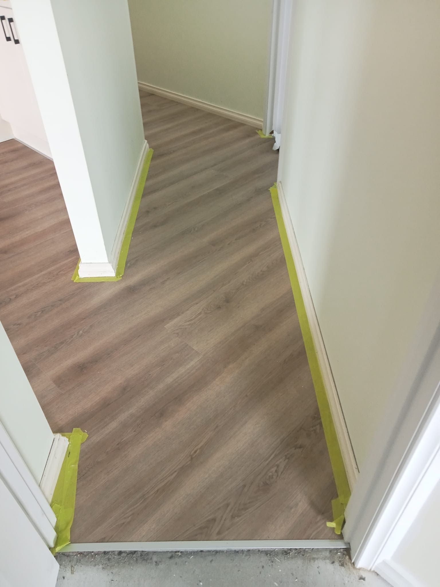 Diagonal wood-look flooring installed in a hallway — BLB Flooring Solutions in Newcastle, NSW