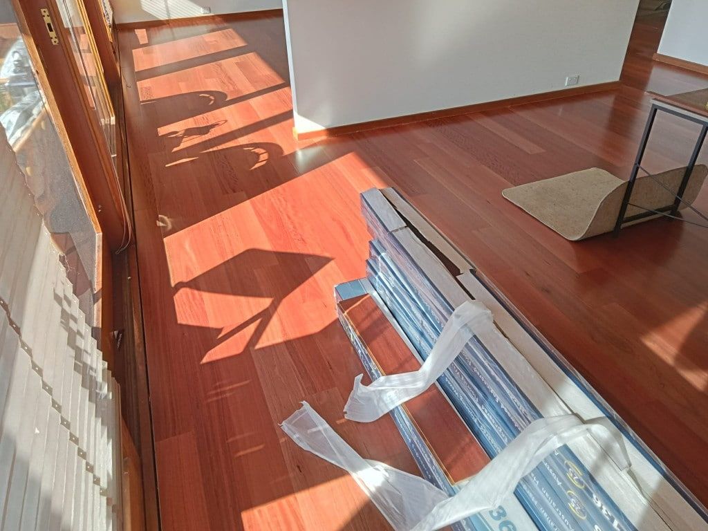 Hardwood Floor With Sunlight Casting Shadows — BLB Flooring Solutions in Newcastle, NSW