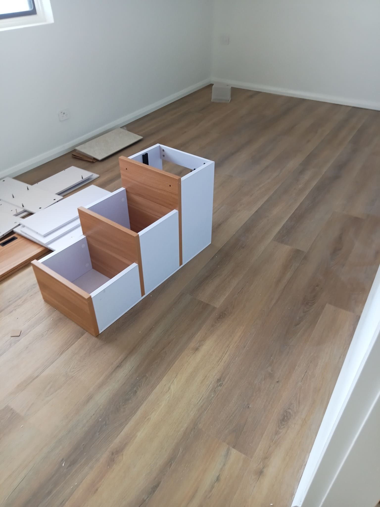 A Stepped Cabinet With Wood-toned Drawers — BLB Flooring Solutions in Raymond Terrace, NSW