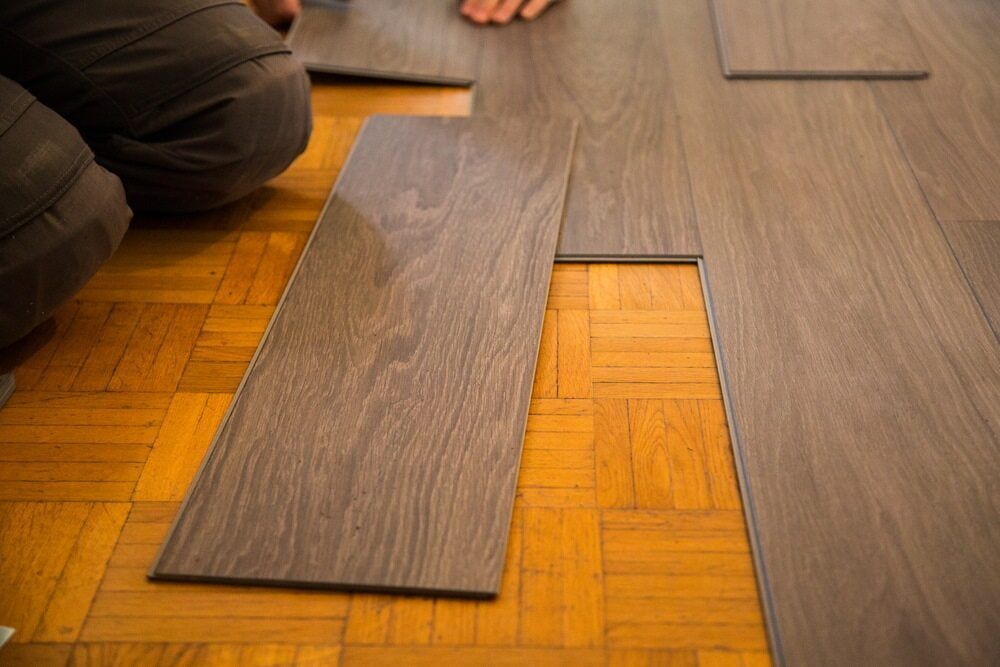 Person Installing New Flooring — BLB Flooring Solutions in Central Coast, NSW