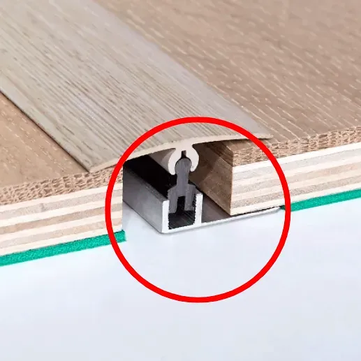 Metal Floor Transition Strip Installed Between Two Wooden Planks — BLB Flooring Solutions in Central Coast, NSW