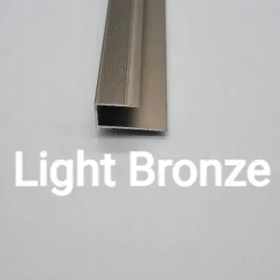 A Light Bronze Aluminum Profile is Sitting on a White Surface — BLB Flooring Solutions in Darawank, NSW