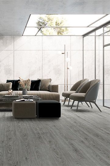 A Living Room With a Couch , Chairs , and a Coffee Table — BLB Flooring Solutions in Darawank, NSW