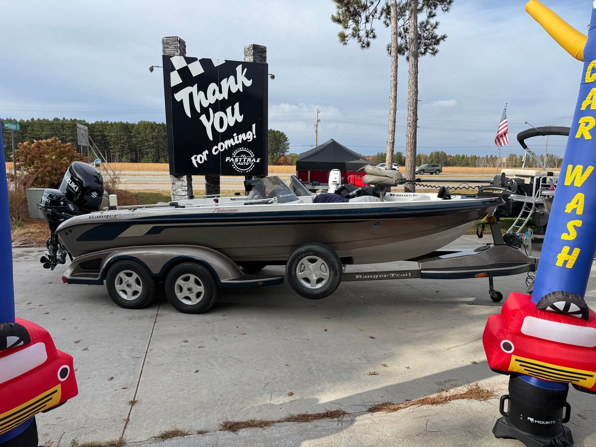 Bass boat on trailer in front of