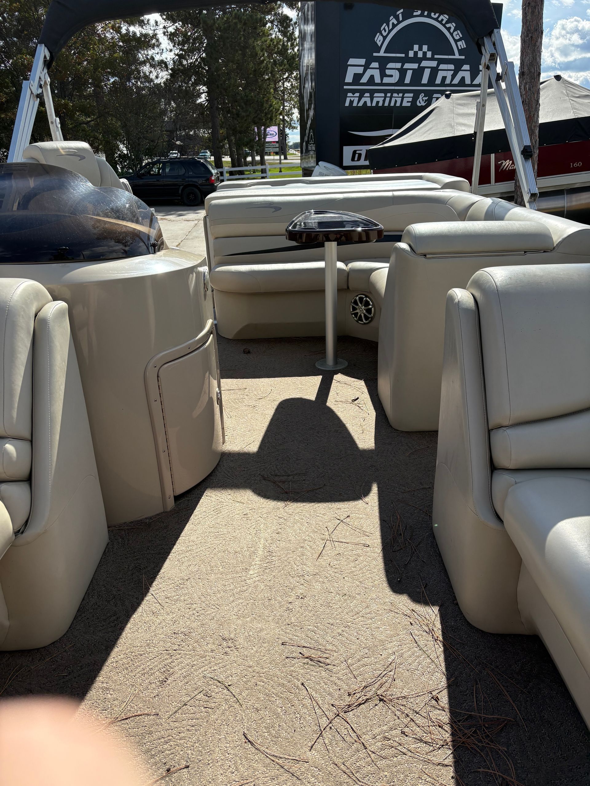 Pontoon boat with beige seats and a table. A