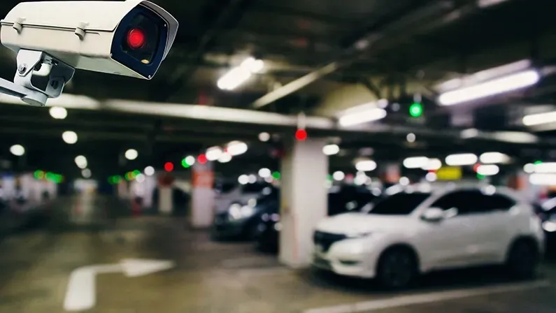 CCTV, security indoor camera system operating with blurred image of under ground indoor car parking garage area, RFID solution management system, surveillance security and safety technology concept