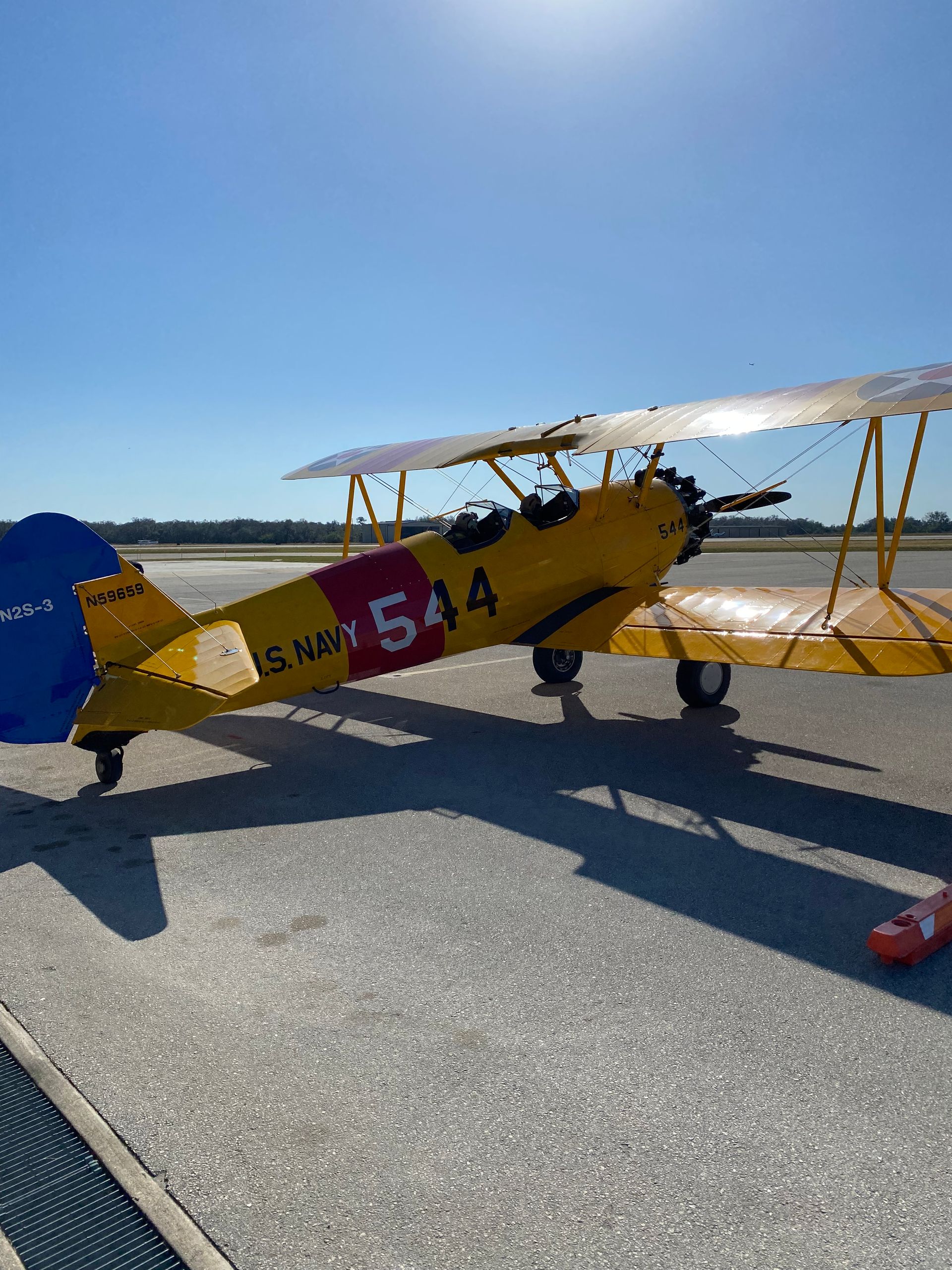 A yellow plane with the number 514 painted on it