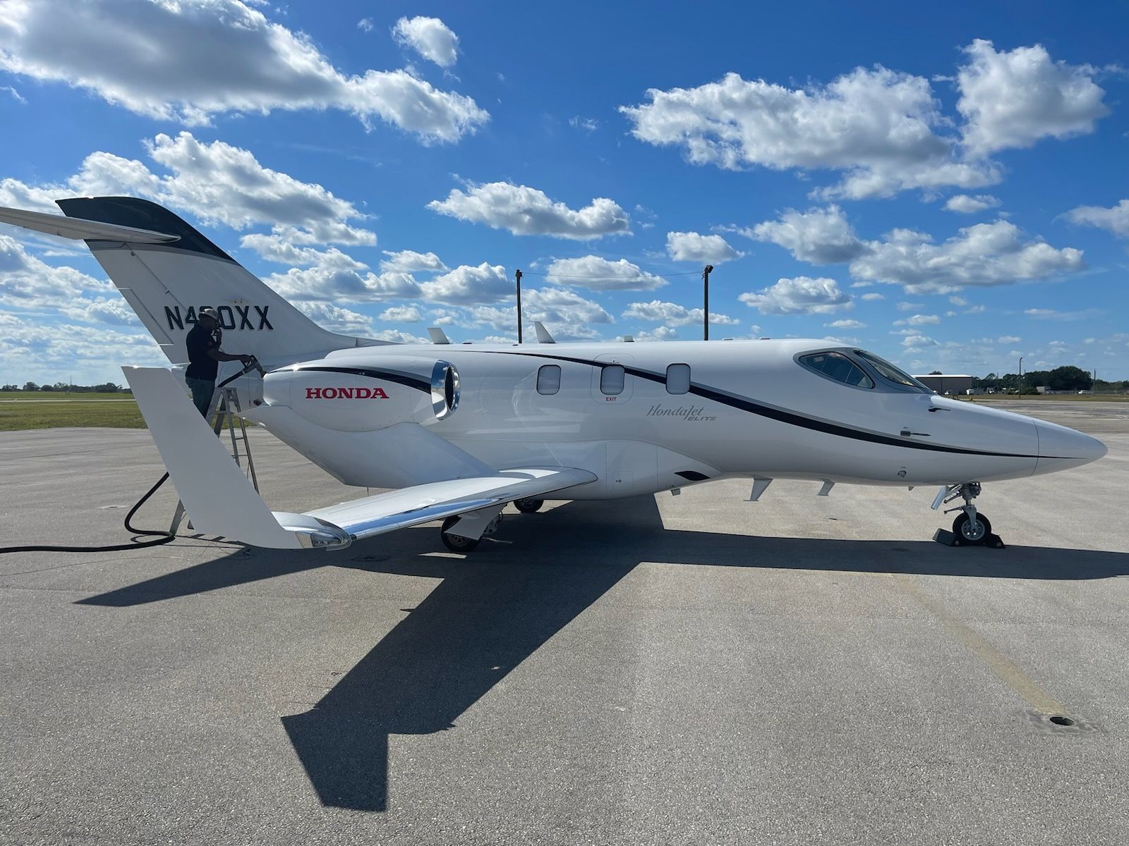 A small white airplane is parked on a runway.