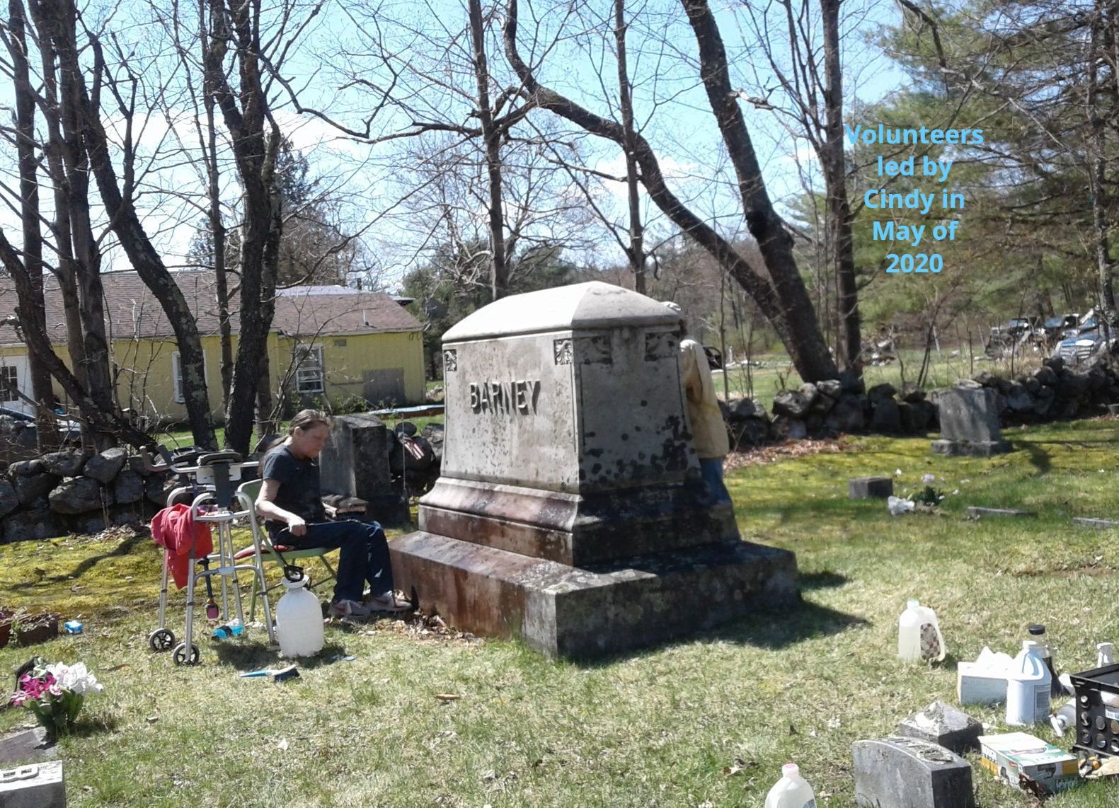 Volunteer crew cleaning large family monument