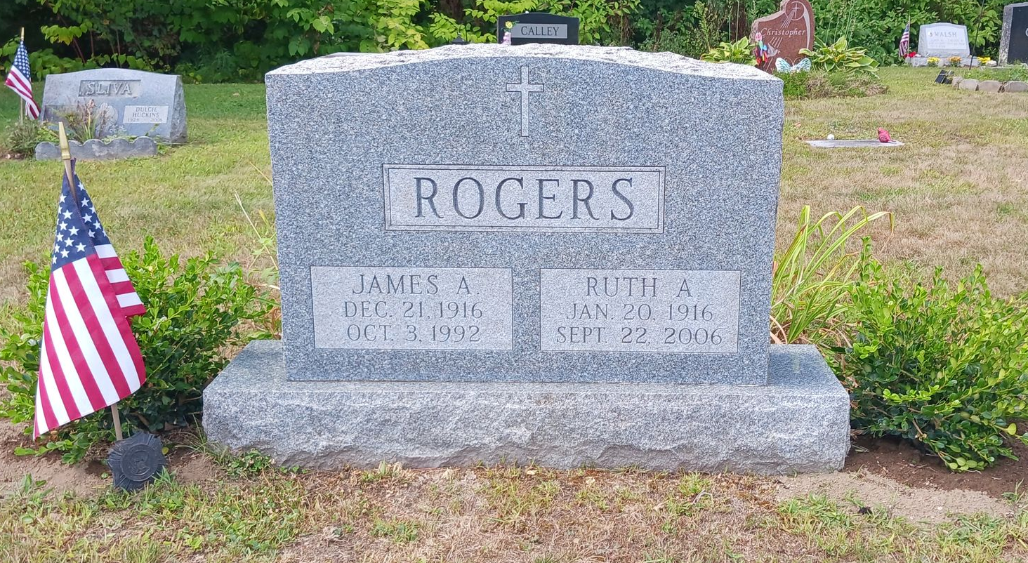Roger family headstone with a US flag to the left