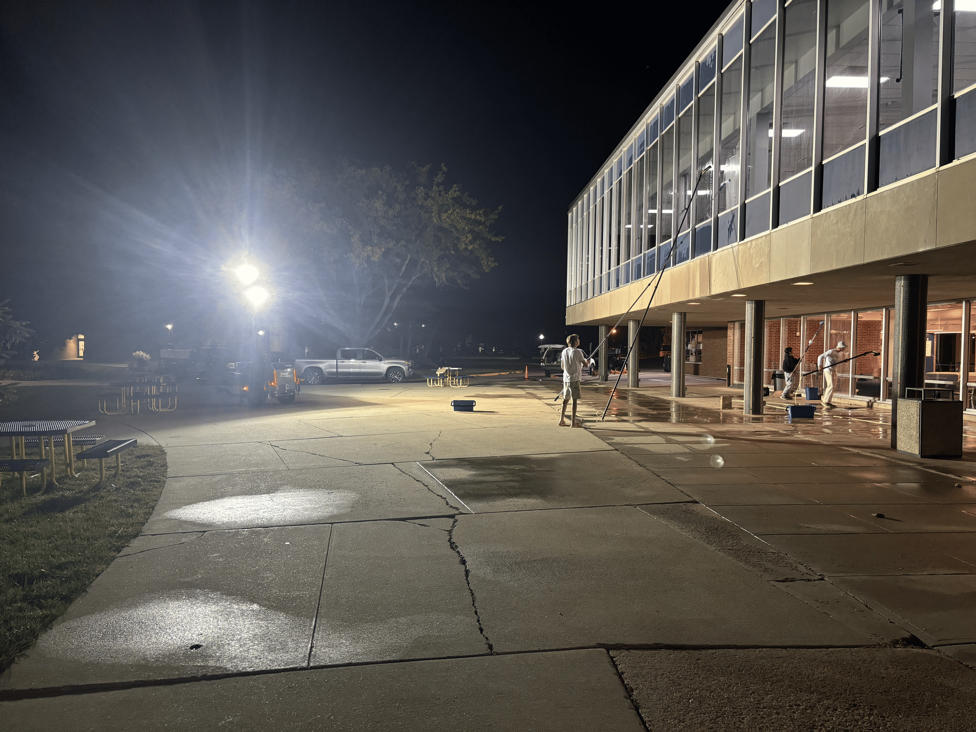 A large building with a lot of windows is lit up at night.