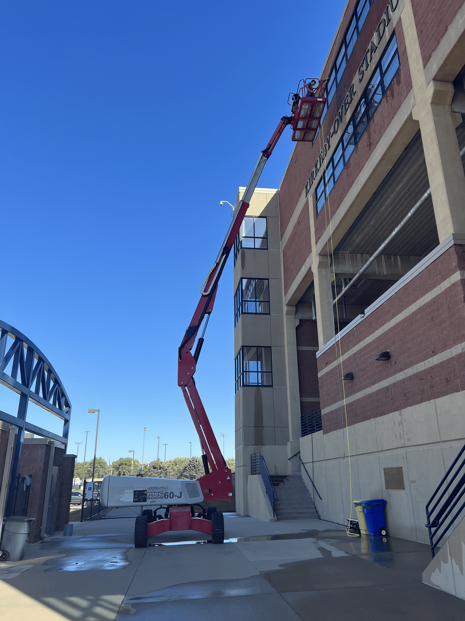 A red crane is working on the side of a building