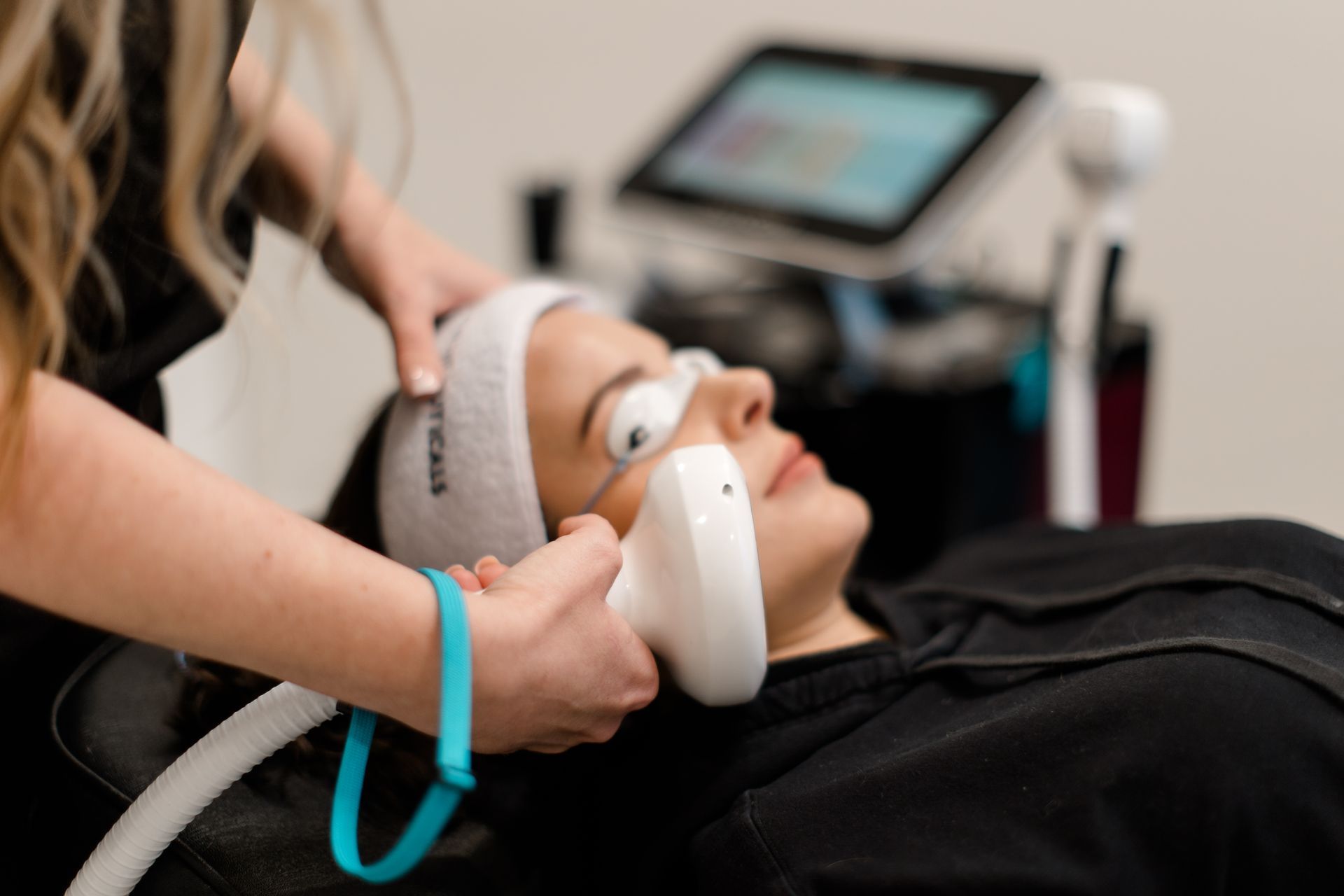 A woman is getting a laser treatment on her face.