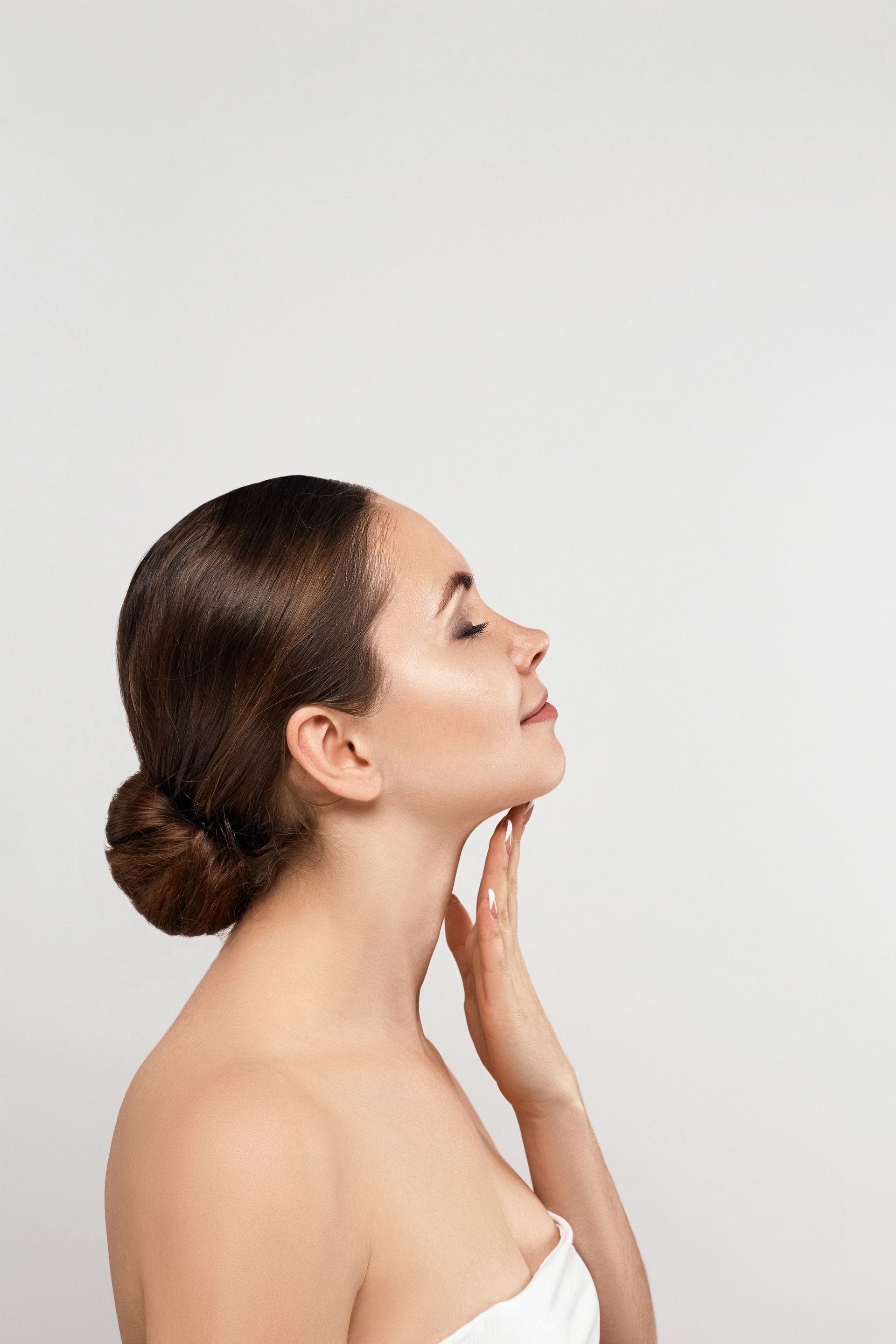 A woman touching her neck