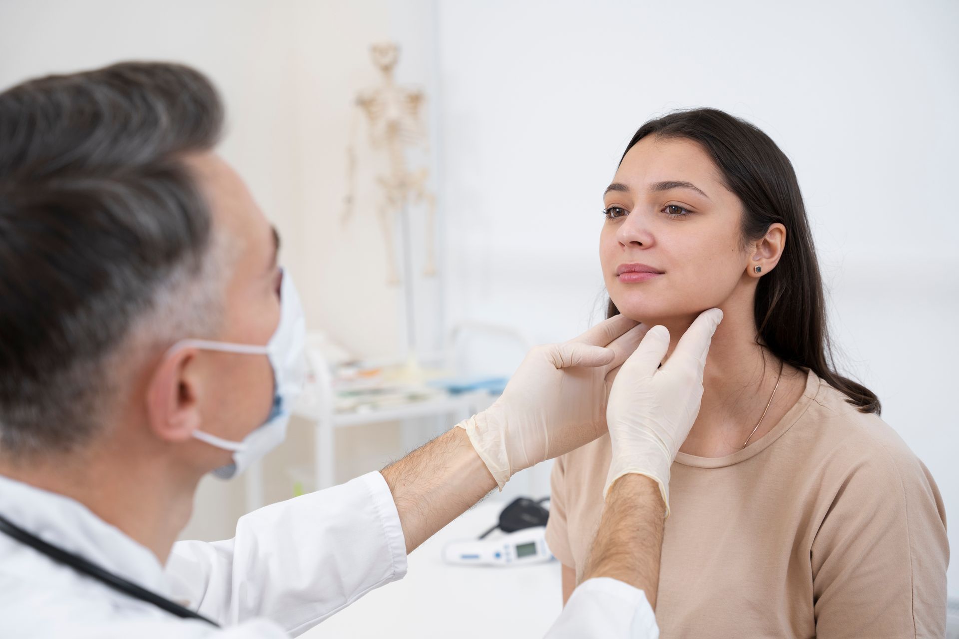 A doctor is examining a woman 's thyroid gland.