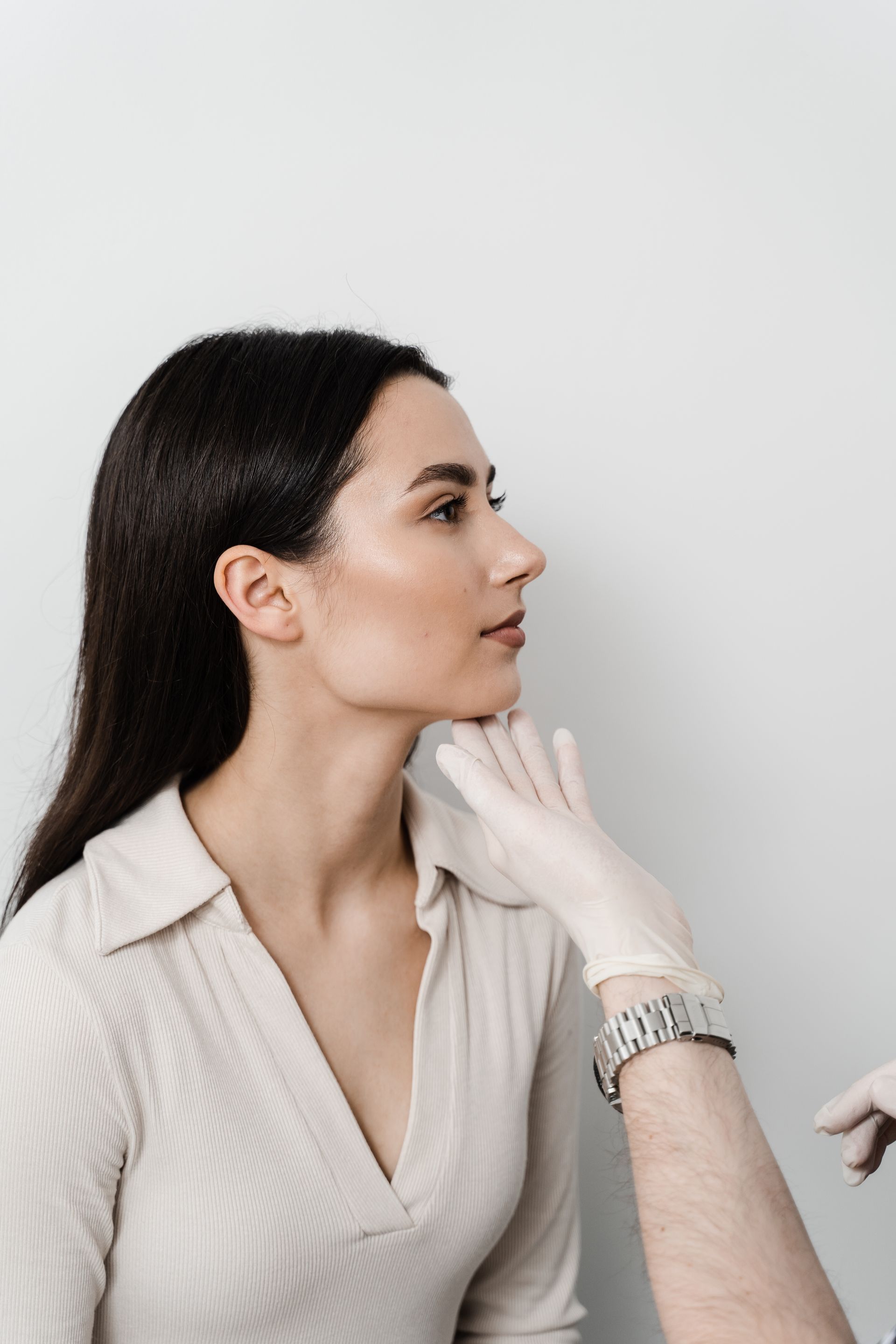A woman is getting a botox injection in her face.