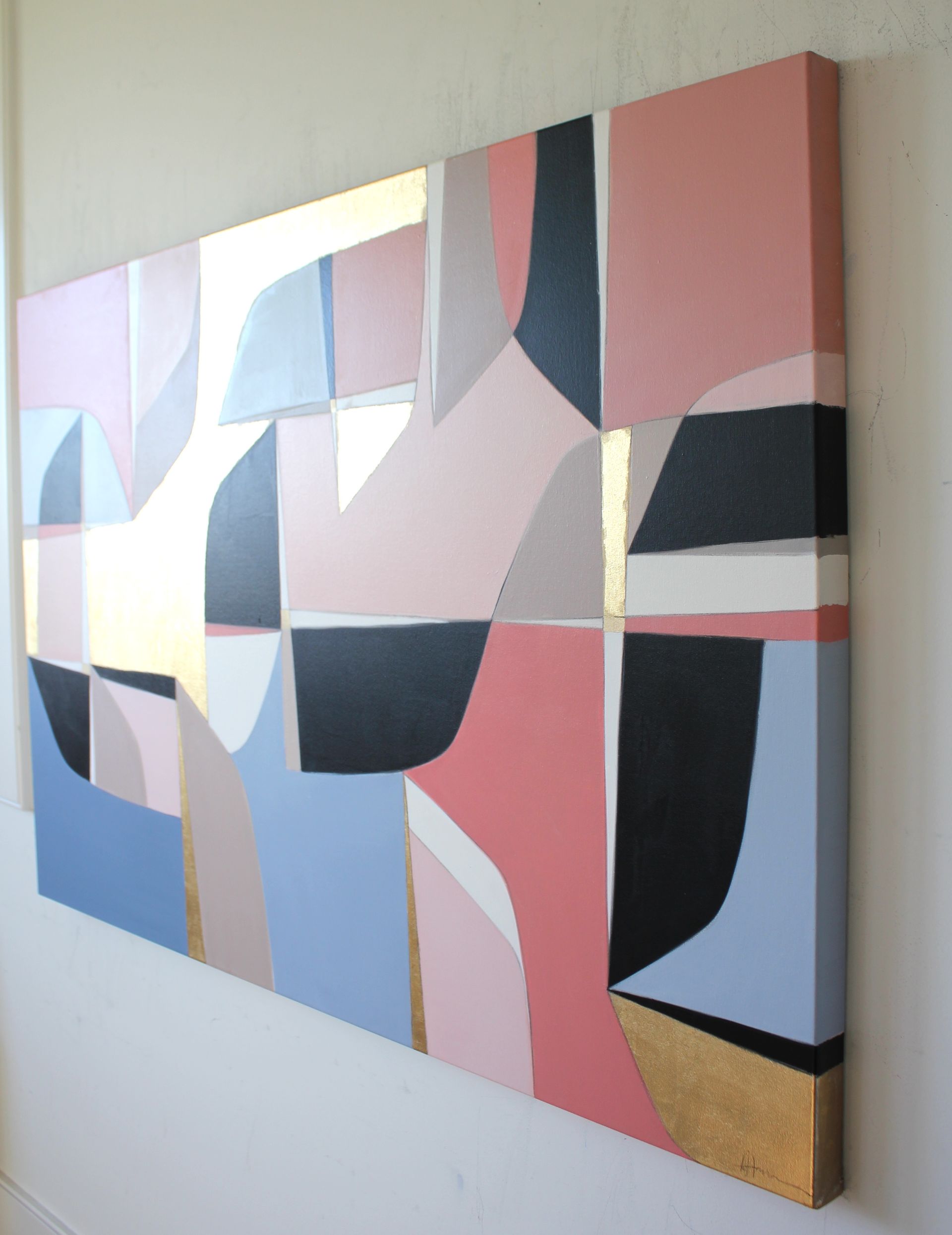 A large painting is hanging on a white wall