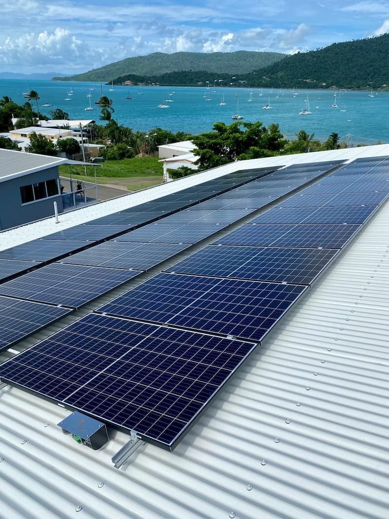 A Row Of Solar Panels On The Roof Of A Building Overlooking The Ocean — Solar Power Whitsunday In Cannon Valley, QLD