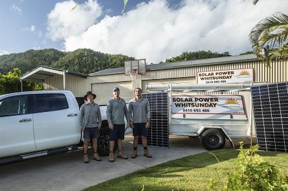 Three Men Are Standing In Front Of A Truck And Trailer — Solar Power Whitsunday In Cannon Valley, QLD