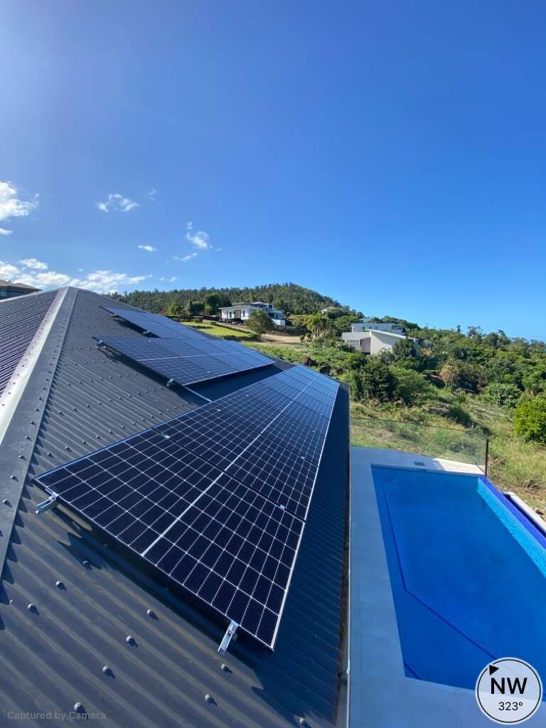 A Roof With Solar Panels And A Pool In The Background — Solar Power Whitsunday In Cannon Valley, QLD
