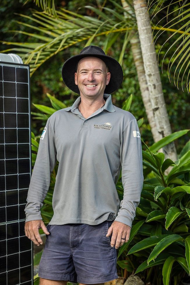 Workman Standing Next To Solar Panel — Solar Power Whitsunday In Midge Point, QLD