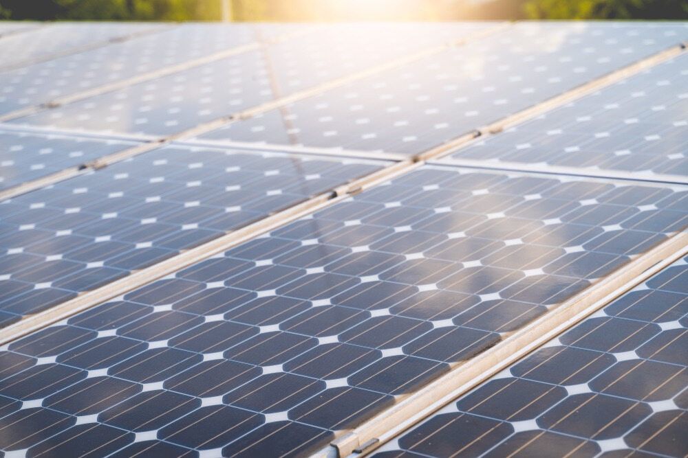 A Row Of Solar Panels On A Roof With The Sun Shining Through Them — Solar Power Whitsunday In Airlie Beach, QLD