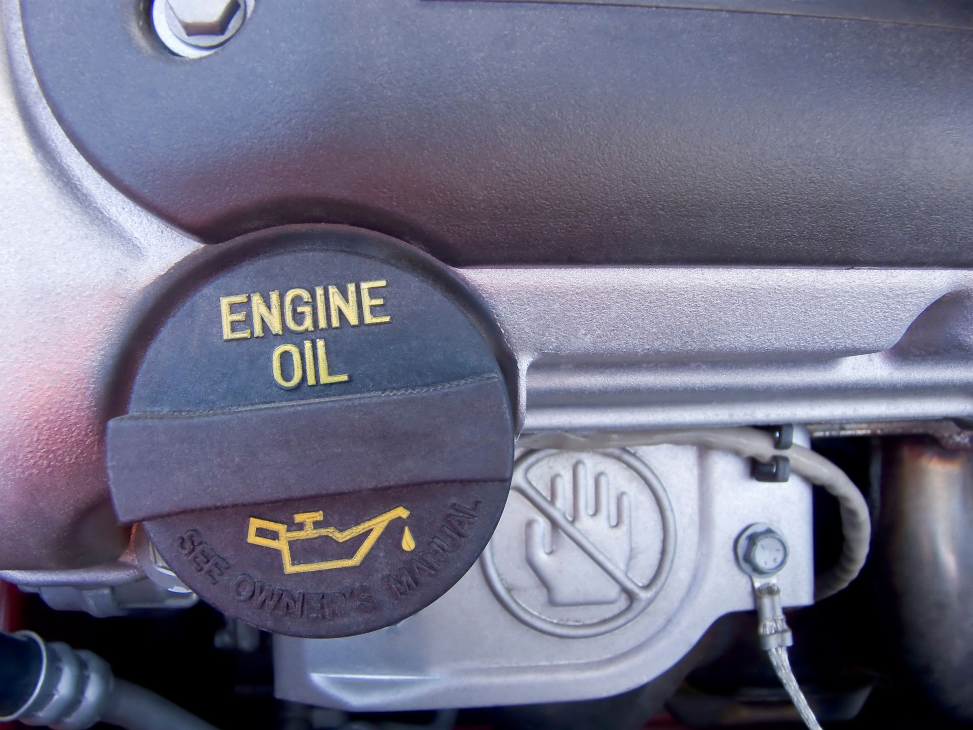 Engine oil cap on a car engine, black cap with 