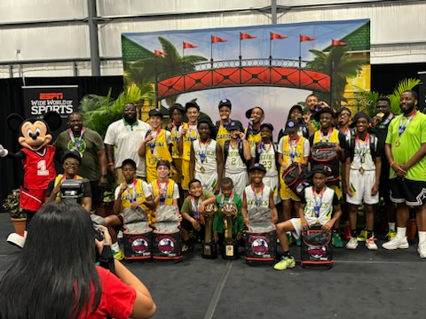 A group of young boys are posing for a picture with a mickey mouse mascot.