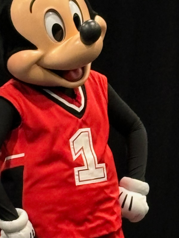 Mickey mouse is wearing a red jersey with the number 1 on it