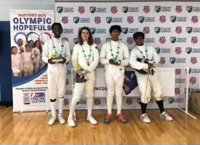 A group of people are standing in front of a sign that says olympic hopefuls.