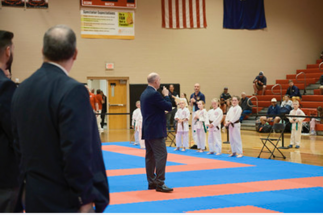 A group of people standing on a mat in a gym