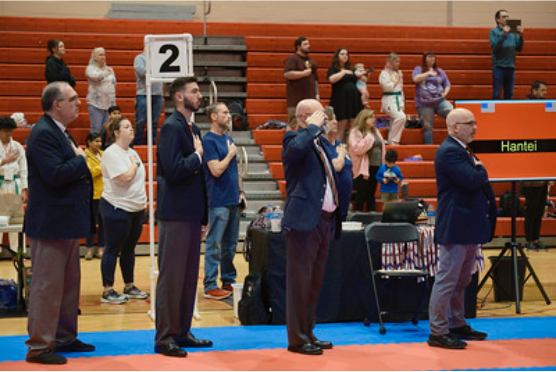 A group of people standing in front of a sign that says 2