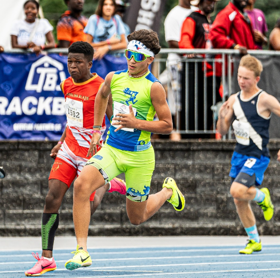 A group of young men are running on a track.