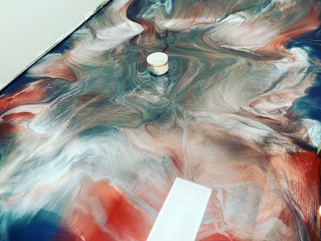 metallic epoxy floor with a combination of blue, red and white colors pattern