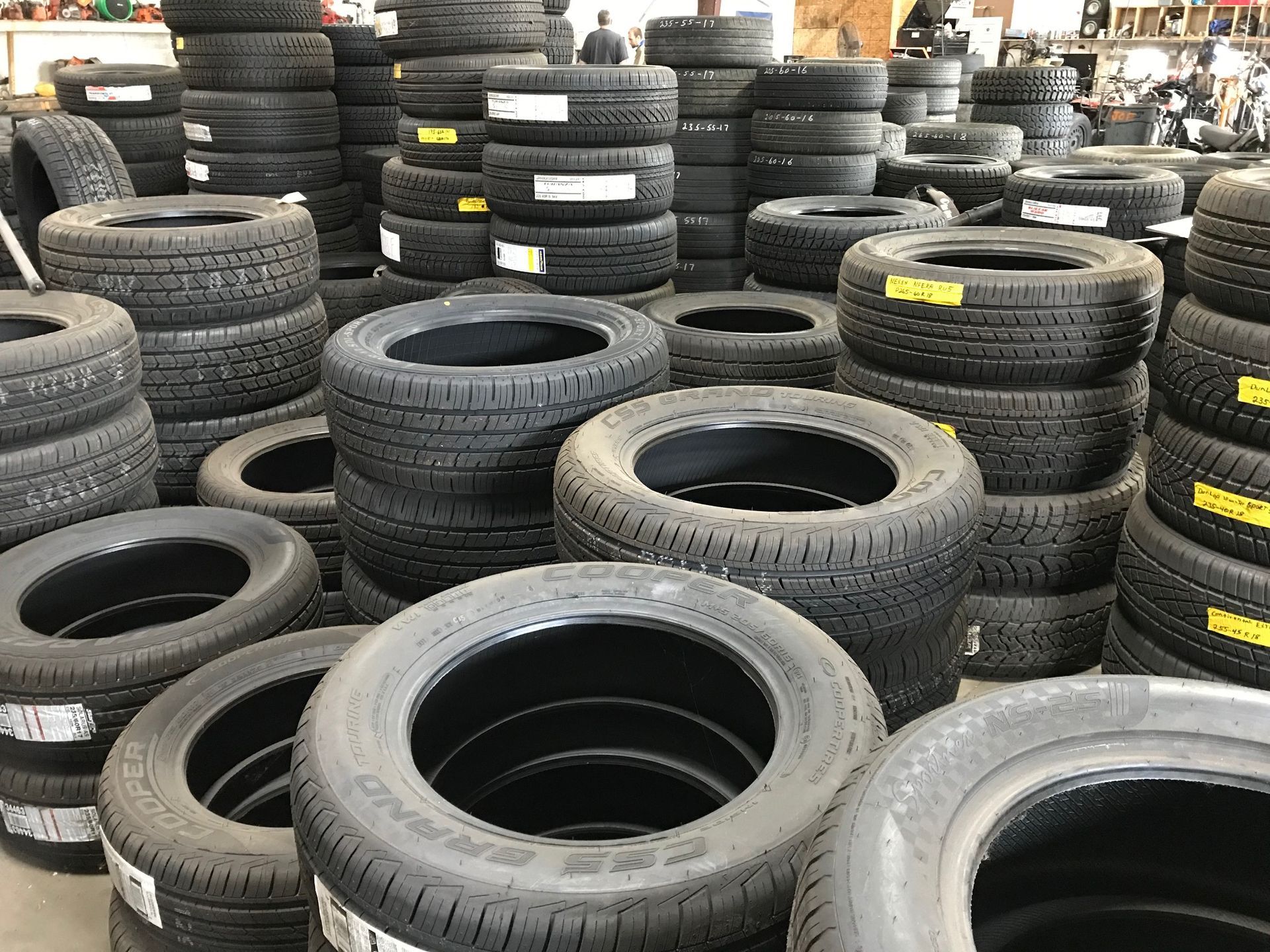 A warehouse filled with lots of tires stacked on top of each other.