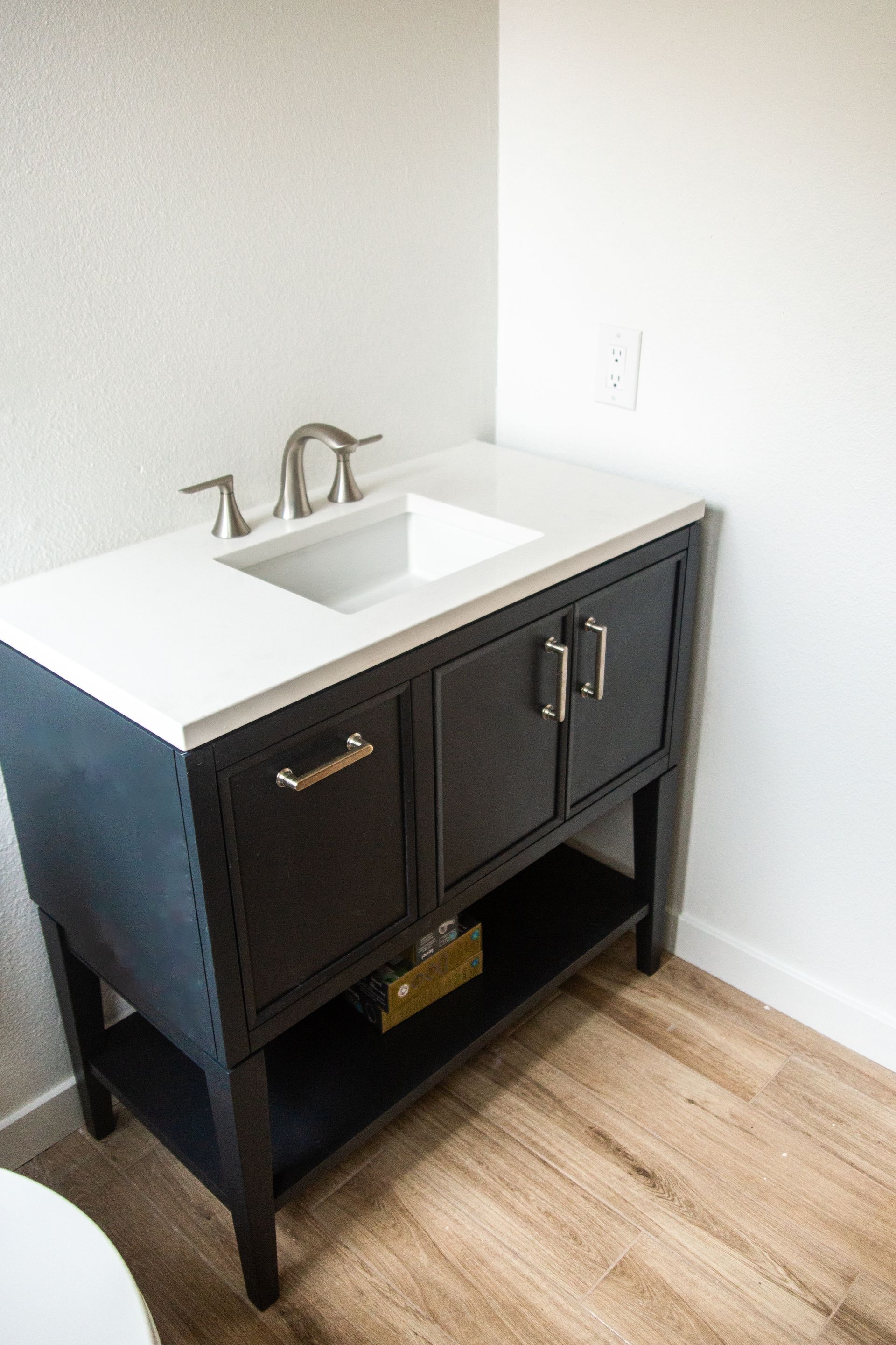 A remodeled bathroom vanity with a sink and a toilet in an ADU.