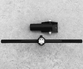 A black and white photo of two tools on a concrete surface.