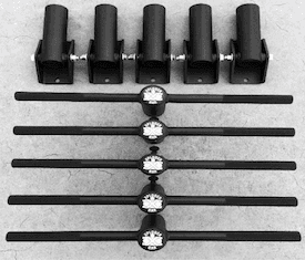 A black and white photo of a set of dumbbells on a concrete surface.