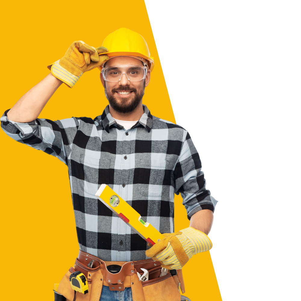 A man wearing a hard hat and gloves is holding a level.