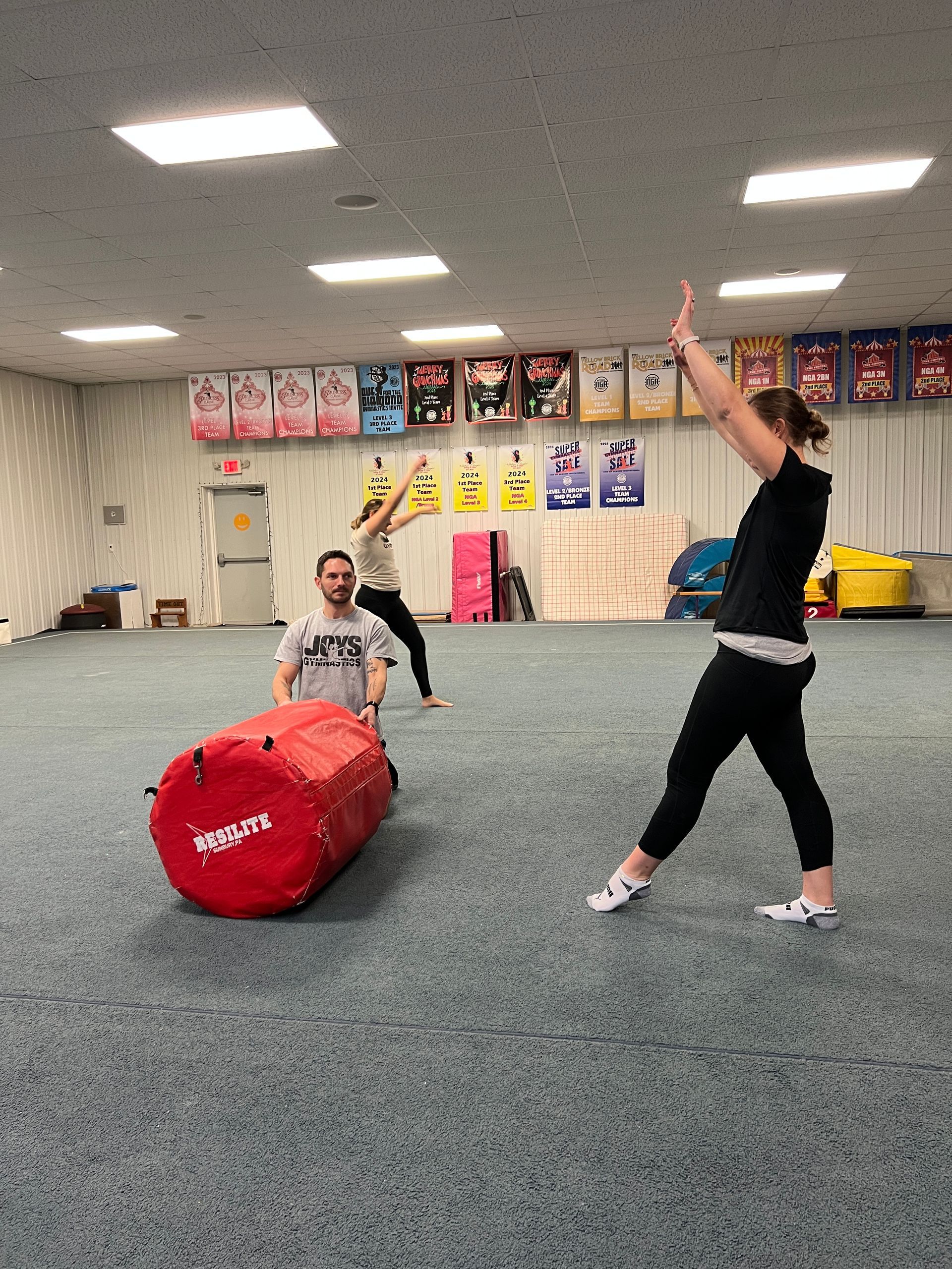 A group of people are playing a game in a gym.