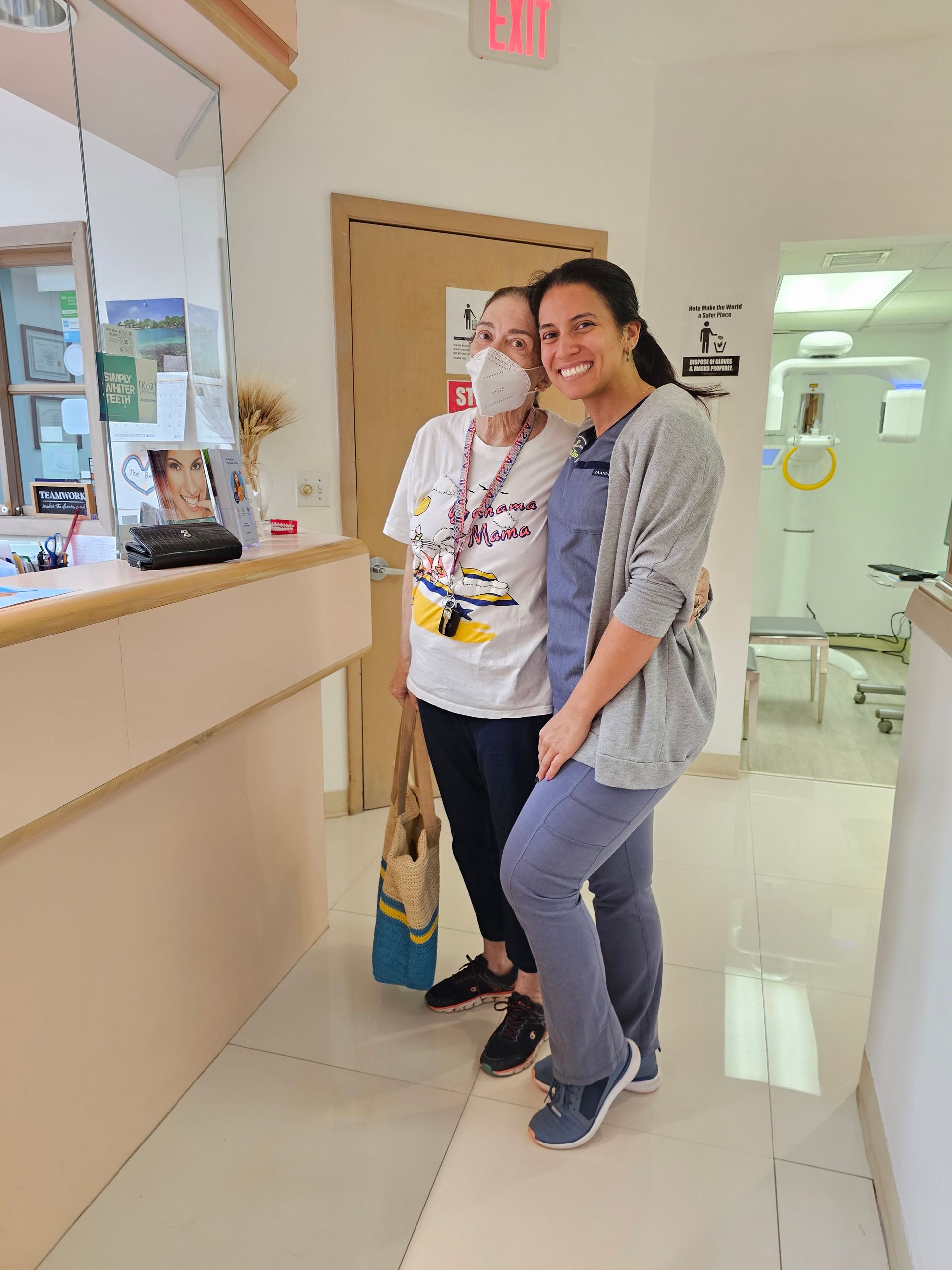 Two women wearing masks are standing next to each other in a hospital.