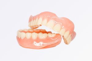 A close up of a pair of dentures on a white background.