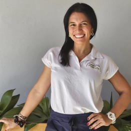 A woman wearing a white shirt with the word lacoste on it