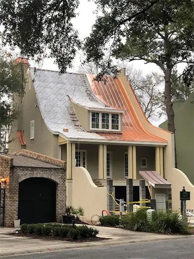 A house with a copper roof is under construction