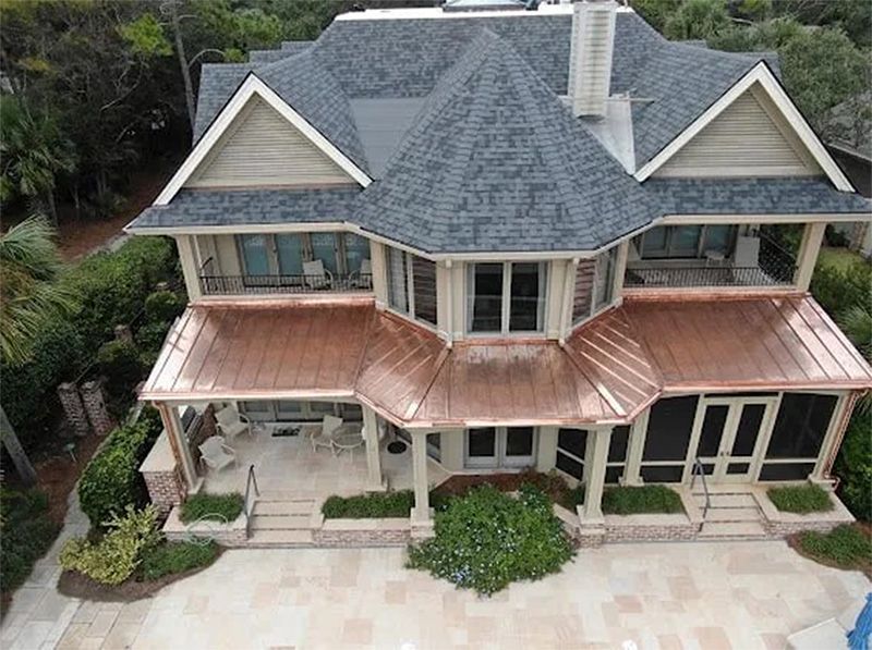 An aerial view of a large house with a copper roof