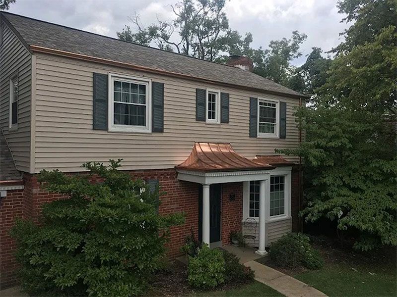 A house with a porch and a copper roof