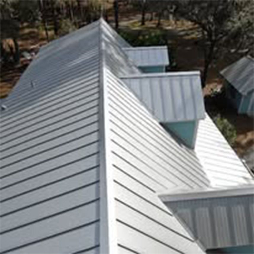 An aerial view of a house with a metal roof.