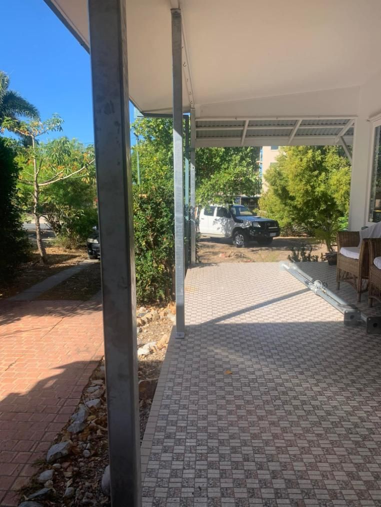 A Car Is Parked Under a Porch Next to A House — Get Stumped Stumping & Maintenance In Bowen, QLD