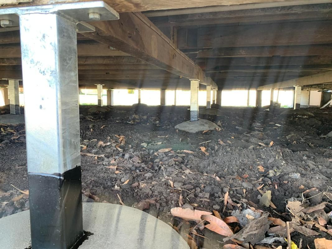 The Bottom of A House with A Lot of Leaves on The Ground — Get Stumped Stumping & Maintenance In Bowen, QLD